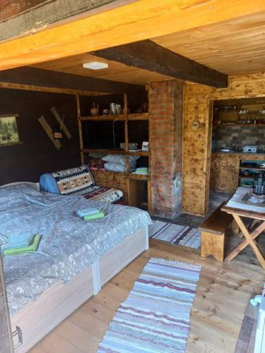 a bedroom with a bed and a table in a room at Etno brvnara TAMARA in Kremna