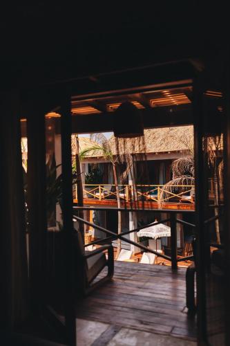 a view of a porch with a table and chairs at Naked Hotel Zipolite -Adults Only- in Zipolite