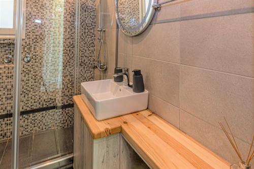 a bathroom with a sink and a shower at Ventiri Suite 2 in Athens