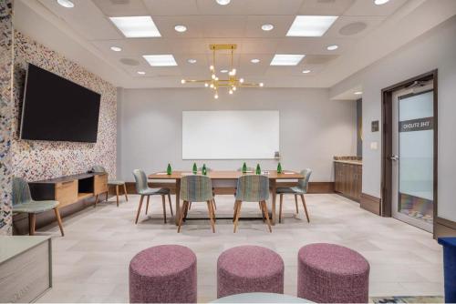 a conference room with a table and chairs and a whiteboard at Crowne Plaza Shenandoah - The Woodlands Area by IHG in The Woodlands