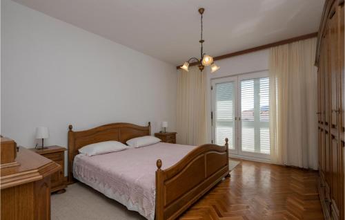 ein Schlafzimmer mit einem Bett und einem großen Fenster in der Unterkunft Amazing Apartment In Katuni With Kitchen in Katuni