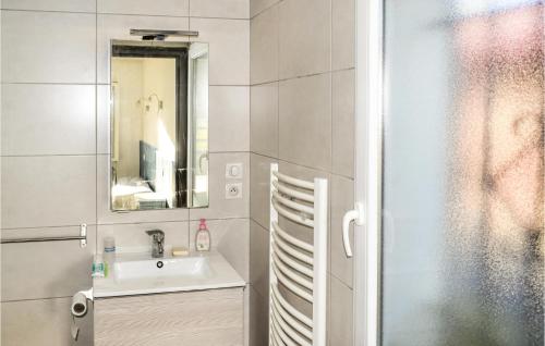a bathroom with a sink and a mirror at Lovely Apartment In Saint-pe-sur-nivelle With House A Panoramic View in Saint-Pée-sur-Nivelle