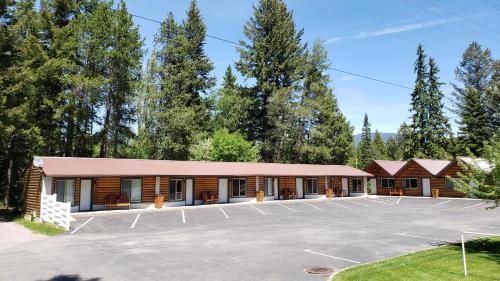 a large parking lot in front of a building at Beargrass Lodging & RV Resort in Hungry Horse
