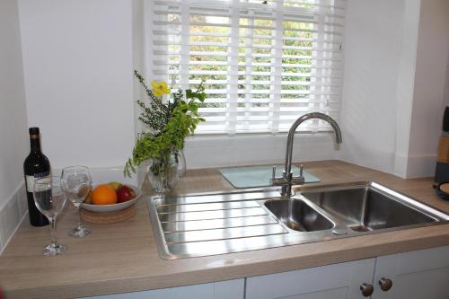a kitchen counter with a sink and a window at Rossett Pike in Bowness-on-Windermere