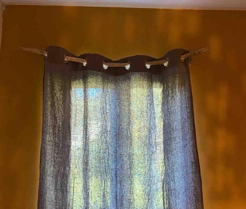 a curtain hanging from a curtain rod in a room at Maison - Terrasse - Jardin in Préchacq
