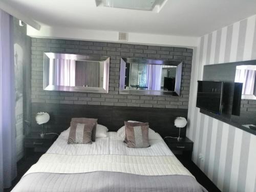 サンドミエシュにあるWilla Sandomierskaのベッドルーム1室(白いベッド1台、鏡2つ付)