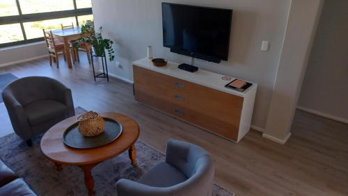 a living room with a flat screen tv and furniture at A Superb apartment in Still Bay in Stilbaai