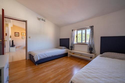 a bedroom with two beds and a window at Isola Bella in Korčula
