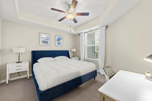 a bedroom with a blue bed and a ceiling fan at Designer Apt with Jacuzzi, Sky Lounge, Gym Access in Sparks