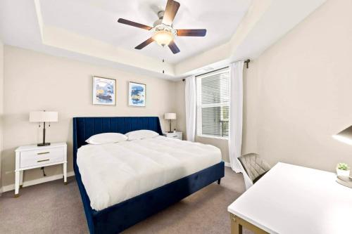 a bedroom with a blue bed and a ceiling fan at Chic Apt with Jacuzzi, Pool Nr Casino & Shopping in Sparks