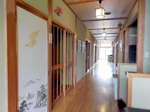 a hallway of an office building with a long corridor at Sado Ryosou Minato in Sado