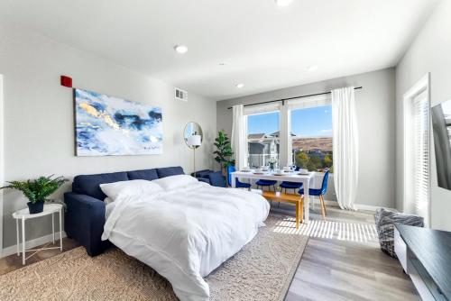 a bedroom with a bed and a dining room with a table at Chic Apt w Jacuzzi, Pool, BBQ, & Mountain Views in Sparks