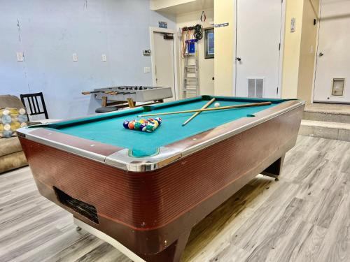 a pool table with billiard balls on top of it at DT Reno - 4BR Home with Patio, BBQ Grill, Games Room in Reno
