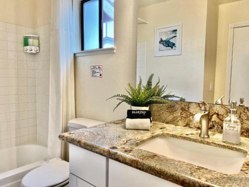 a bathroom with a sink and a toilet at DT Reno - 4BR Home with Patio, BBQ Grill, Games Room in Reno