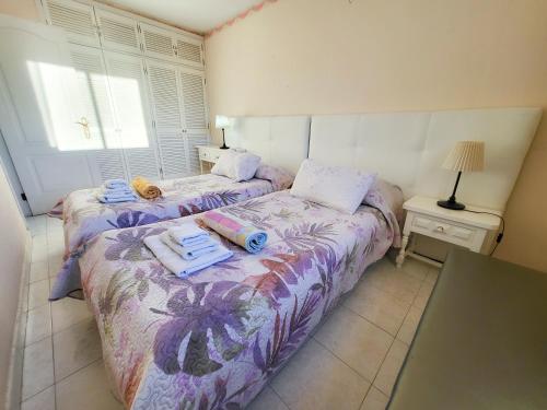 ein Schlafzimmer mit 2 Betten und Handtüchern darauf in der Unterkunft eldorado blue in Playa de las Americas