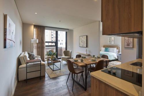 a kitchen and living room with a room with a couch and a table at Caluce Apt 3A by Letoh in Chía