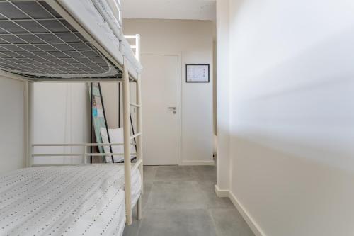 a bedroom with a bunk bed and a hallway at De Hoog Velden 12 in Pelt