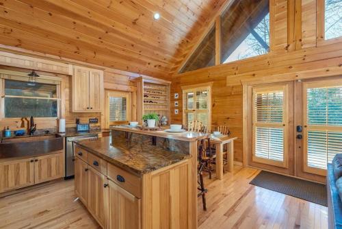 a kitchen with wooden walls and a wooden ceiling at Fully Stocked Cabin Retreat w/ Game Room & Pond! in Marion