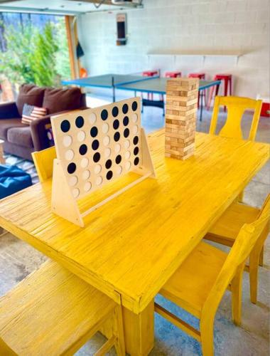a wooden table with a game of checkers on it at Fully Stocked Cabin Retreat w/ Game Room & Pond! in Marion