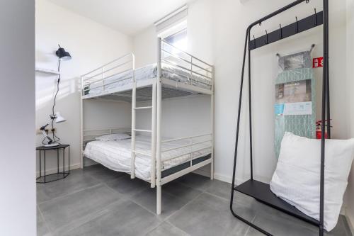 a bedroom with two bunk beds in a room at De Hoog Velden 12 in Pelt