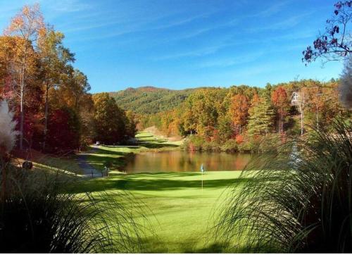 a view of a golf course with a lake at Fully Stocked Cabin Retreat w/ Game Room & Pond! in Marion