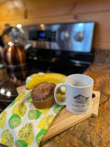 a cupcake sitting on a napkin next to a coffee mug at Fully Stocked Cabin Retreat w/ Game Room & Pond! in Marion