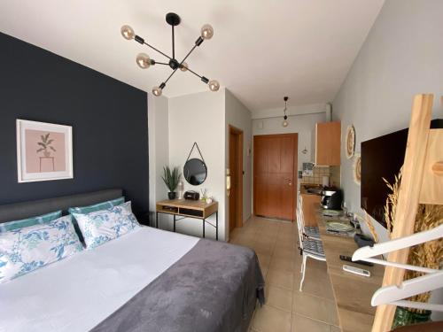 a bedroom with a large bed and a kitchen at B6 COQUETTE in Nea Chili