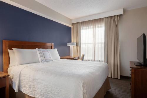 a hotel room with a bed and a window at Residence Inn Baltimore White Marsh in Baltimore