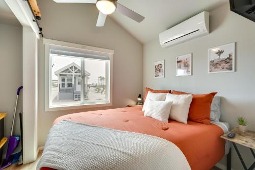 a bedroom with an orange bed and a window at Bullhead City Vacation Rental with Resort Pool! in Bullhead City