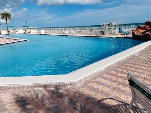 a large swimming pool next to the beach at Amazing Studio on Daytona Beach in Daytona Beach
