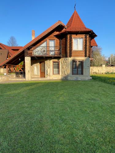 a house with a large yard in front of it at Sofiya in Mykulychyn