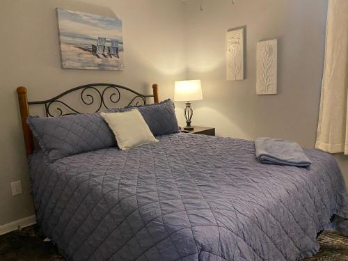 a bedroom with a bed with a purple comforter at Gulf Shores Plantation 4307 by ALBVR - New Upgraded Condo and Building - Great Amenities in Gulf Highlands