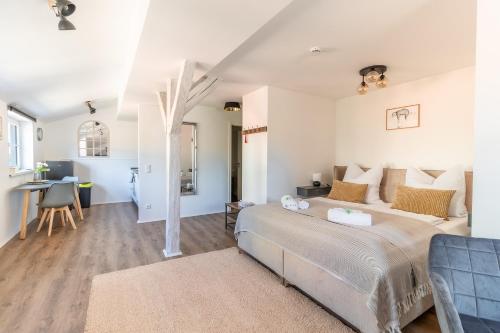 a bedroom with a bed and a living room at Daniels Apartment an der Schloßbrücke in Meißen