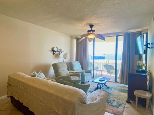 a living room with a couch and chairs and a tv at Gulf Village 312 by ALBVR - Oversized balcony offers beautiful, unobstructed indirect views in Gulf Shores