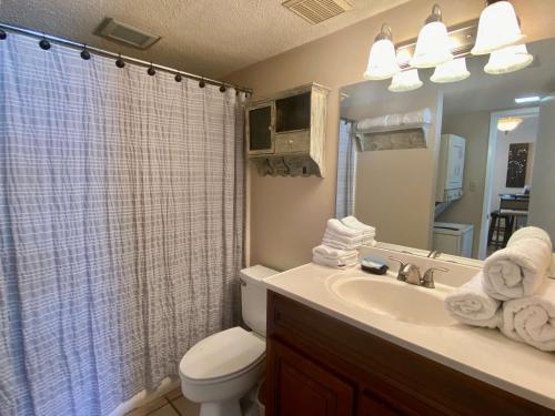 a bathroom with a toilet and a sink and a shower at Gulf Village 312 by ALBVR - Oversized balcony offers beautiful, unobstructed indirect views in Gulf Shores