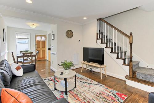 a living room with a couch and a flat screen tv at Beautiful 3br 2ba Colonial House CozySuites in Alexandria