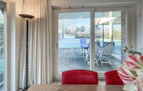 a dining room with a sliding glass door to a patio at Cozy Home In Havelte With Wifi in Havelte