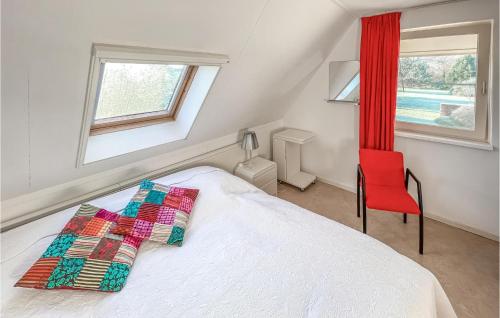a bedroom with a bed and a red chair at Cozy Home In Havelte With Wifi in Havelte