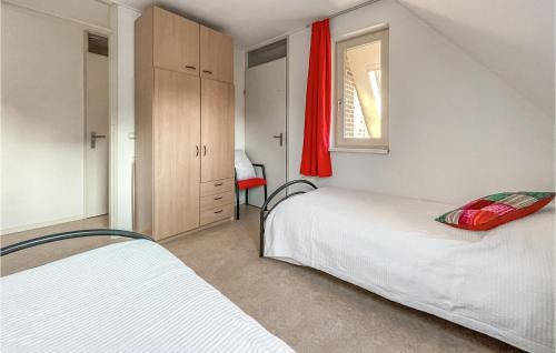 a small bedroom with two beds and a window at Cozy Home In Havelte With Wifi in Havelte
