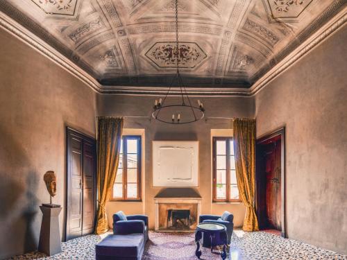 a living room with a coffered ceiling and a fireplace at Palazzo del Settecento in Ravenna