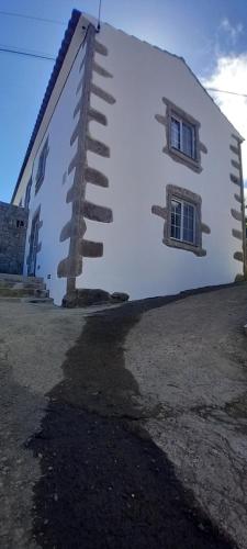 a building with a spiral staircase on the side of it at Fazenda Apartments - Apartment 1 in Lajes das Flores