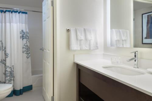 a bathroom with a sink and a toilet and a shower at Residence Inn Savannah Midtown in Savannah