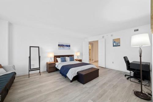 a bedroom with a bed and a desk and a television at Astonishing Ocean Front Condo CozySuites at Showboat in Atlantic City