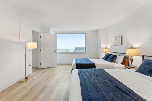 a bedroom with two beds and a large window at Boardwalk 2BR 3BA Condo CozySuites at Showboat in Atlantic City