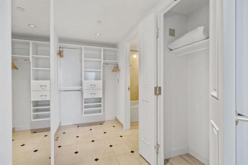a white walk in closet with white shelves at Boardwalk 2BR 3BA Condo CozySuites at Showboat in Atlantic City