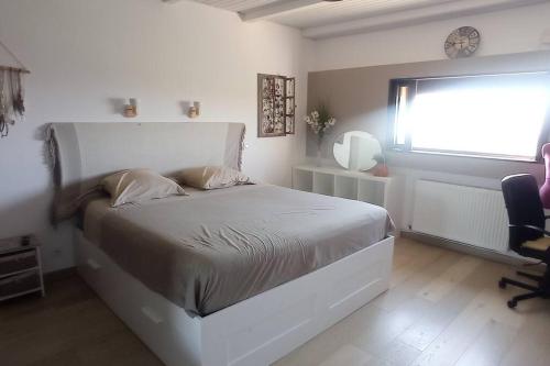 1 dormitorio con cama, escritorio y ventana en Villa avec piscine, vue panoramique ste victoire, en Simiane-Collongue