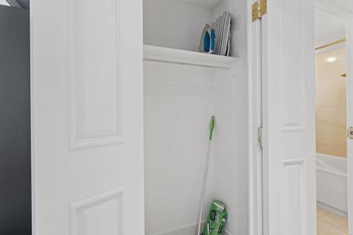 a bathroom with a white door and a shower at Beachfront 1BR 2BA Condo CozySuites at Showboat in Atlantic City