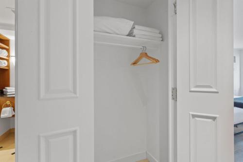a closet with a white door and some towels at Beachfront 1BR 2BA Condo CozySuites at Showboat in Atlantic City