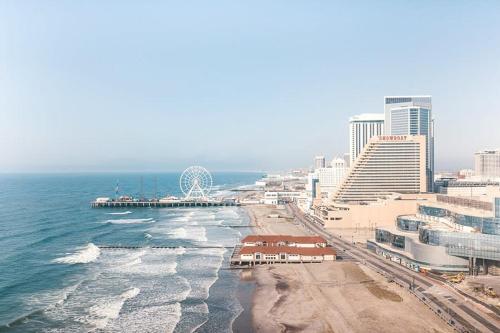 an aerial view of a beach with buildings and the ocean at Sleep SIX 1BR 2BA CozySuites on the Boardwalk in Atlantic City