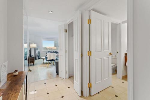a hallway with white doors and a dining room at Sleep SIX 1BR 2BA CozySuites on the Boardwalk in Atlantic City